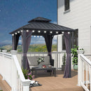 Grey hardtop gazebo with curtains, string lights, and outdoor furniture on a deck, creating a comfortable outdoor space.