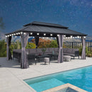 Grey hardtop gazebo with string lights, outdoor furniture, and curtains by a pool, patio shade solution.