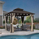 Bronze hardtop gazebo with lights, curtains, and outdoor furniture by a pool.