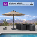 Windproof market umbrella with sturdy base for patio. Beige umbrella and outdoor furniture