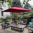 Red cantilever patio umbrella shading outdoor dining set.