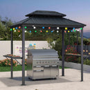 Outdoor hardtop grill gazebo with BBQ, string lights, and Party Time banner, creating an outdoor cooking and party area.