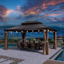 Bronze hardtop gazebo with string lights, dining table, and chairs by pool, patio shade solution.