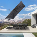 Cantilever patio umbrella providing shade over an outdoor dining set on a patio, with pool and mountain views