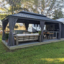 Grey hardtop gazebo with curtains, outdoor seating, and dining area on a wooden deck, patio shade solution