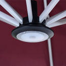 Close-up of PURPLE LEAF patio umbrella LED light with black housing, white ribs, and red canopy