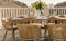 An outdoor dining set with a natural wood table and natural woven chairs