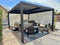 Aluminum louvered pergola with sleek design providing shade for a hot tub area