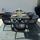 Purple Leaf outdoor dining set: wood grain aluminum table with rope woven chairs and cushions on patio.