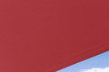 Red polyester fabric for #E Series# cantilever umbrella, showing textured weave detail.