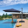 PURPLE LEAF cantilever patio umbrella shades pool, woman enjoying shade on a sunny day. Navy blue umbrella.