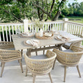 Modern outdoor dining set with rattan chairs, aluminum table, and cushions, perfect for patio dining.