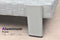 Aluminum frame details of a white rattan chaise lounge, rust-resistant with sturdy structure for outdoor use.