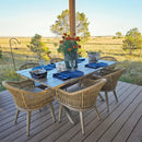 PURPLE LEAF Champagne outdoor dining set: aluminum table, rattan chairs with cushions on deck.
