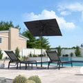 Black square patio umbrella with chaise lounges near a pool