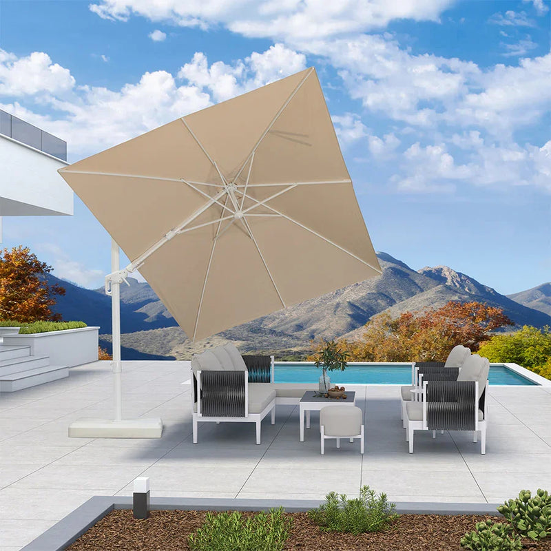 Beige cantilever patio umbrella shading outdoor furniture set on a patio with a pool, patio shade solutions.