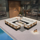 Black L-shaped patio conversation set with grey cushions surrounding a stone fire pit.