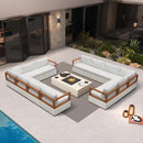 White L-shaped patio conversation set with aluminum frame and white cushions surrounding a stone fire pit table.