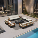 Black wicker patio conversation set with light gray cushions, includes sectional sofa, armchairs, ottomans, and coffee table.