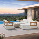 White modular patio conversation set with wood frame and fire pit, beside a pool overlooking a scenic landscape.